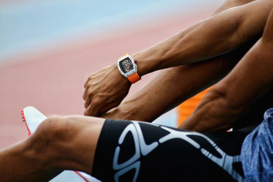 The attractive copy watches have orange rubber straps.